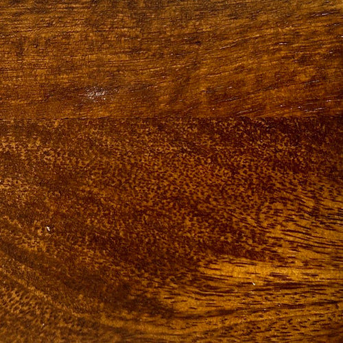 Close-up of a wooden surface with a rich brown color and visible grain.