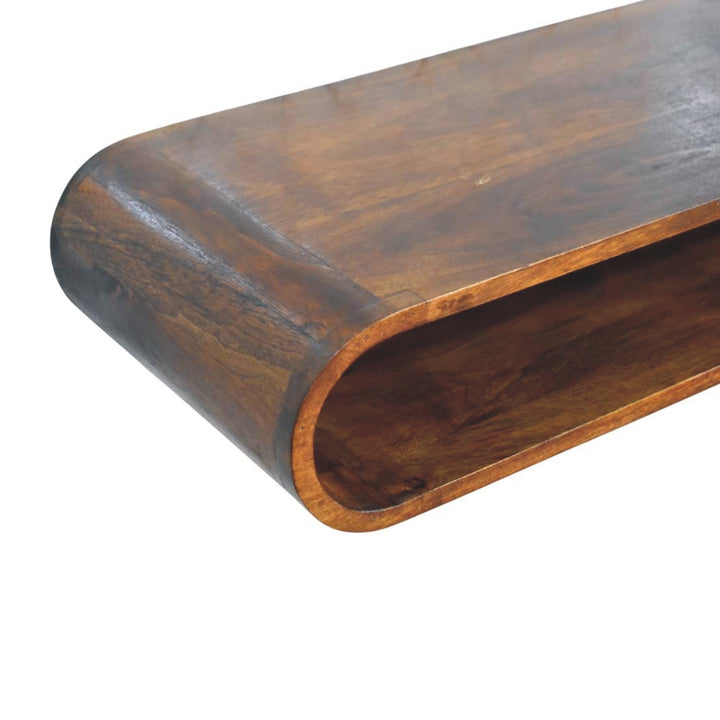 Close-up of the Arc Wall-Mounted Media Console showing its curved design and warm Chestnut finish.