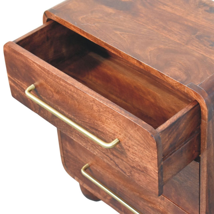 Open drawer of a 3-drawer mango wood nightstand with gold handles showcasing spacious storage.
