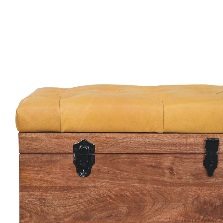 Buffalo Hide Honey Caramel Storage Trunk - Solid Mango Wood Blanket Chest for Bedroom with yellow tufted top.