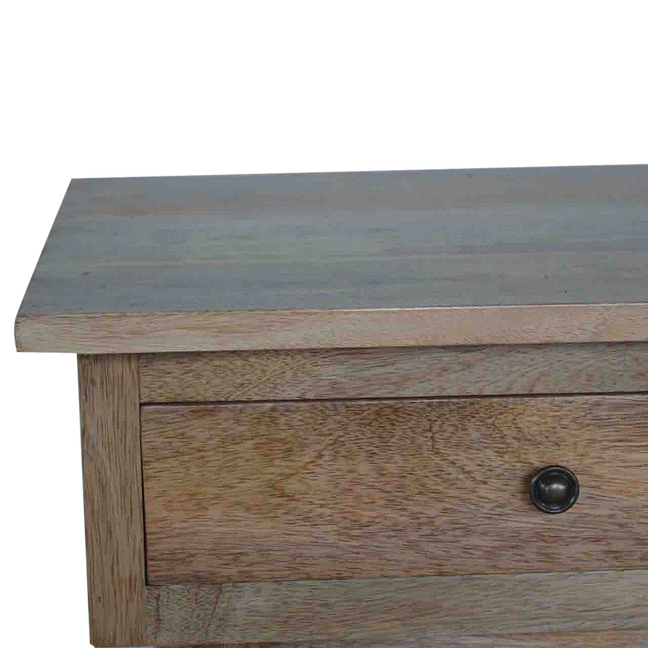 Close-up of the tabletop and drawer of a mango wood hallway console table with a rustic finish.