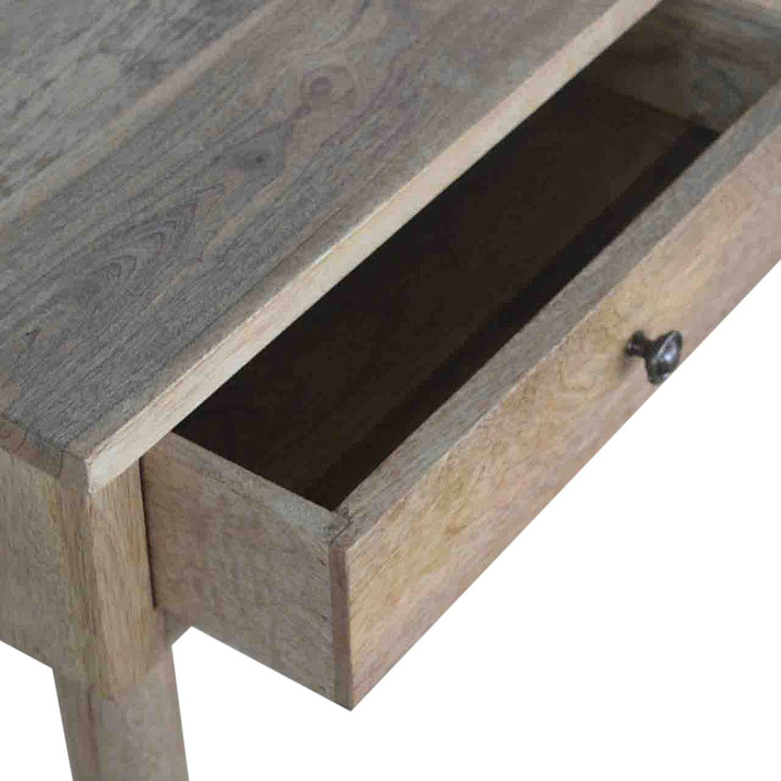 Close-up view of the drawer in a mango wood hallway console table, showcasing craftsmanship and storage space.