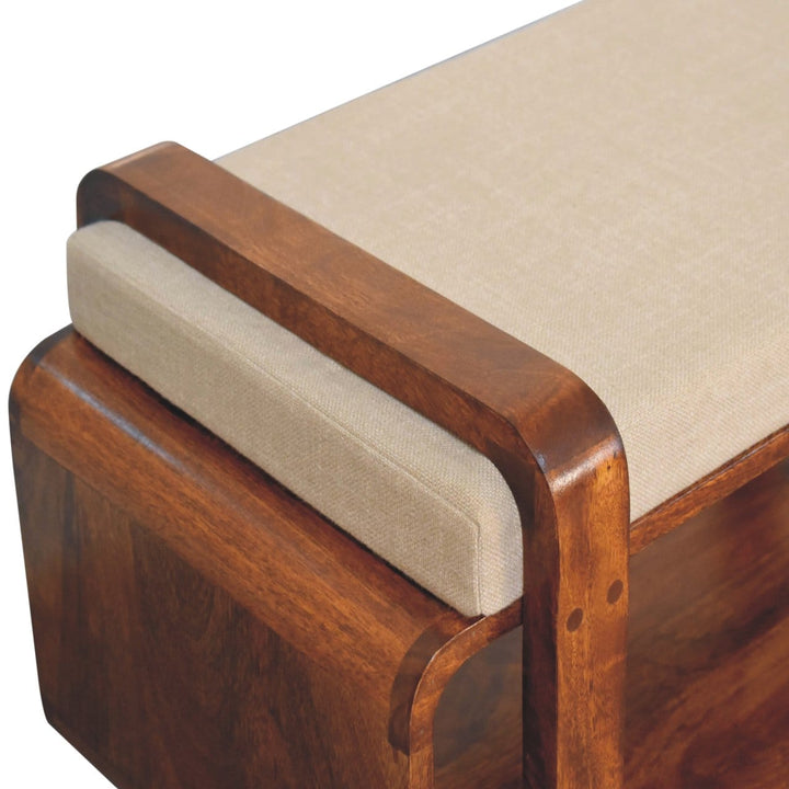 Handcrafted mango wood bench showing a close-up of the solid wood frame and cushioned seating.