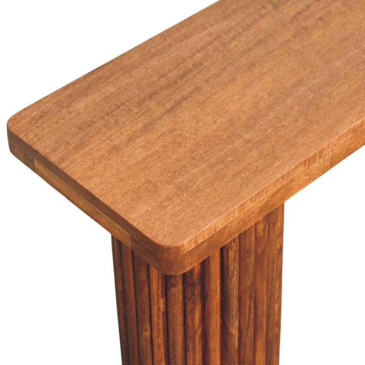 Solid mango wood entryway bench showcasing a rustic design with fluted detailing and a smooth, polished top.