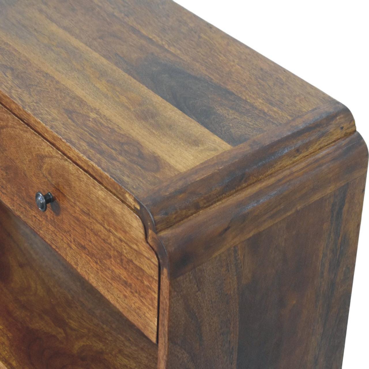 Top view of a solid mango wood console table showcasing the rich wood grain and drawer detail.