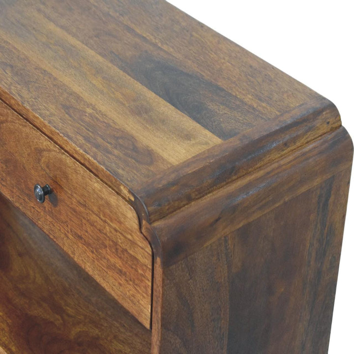 Top view of a solid mango wood console table showcasing the rich wood grain and drawer detail.